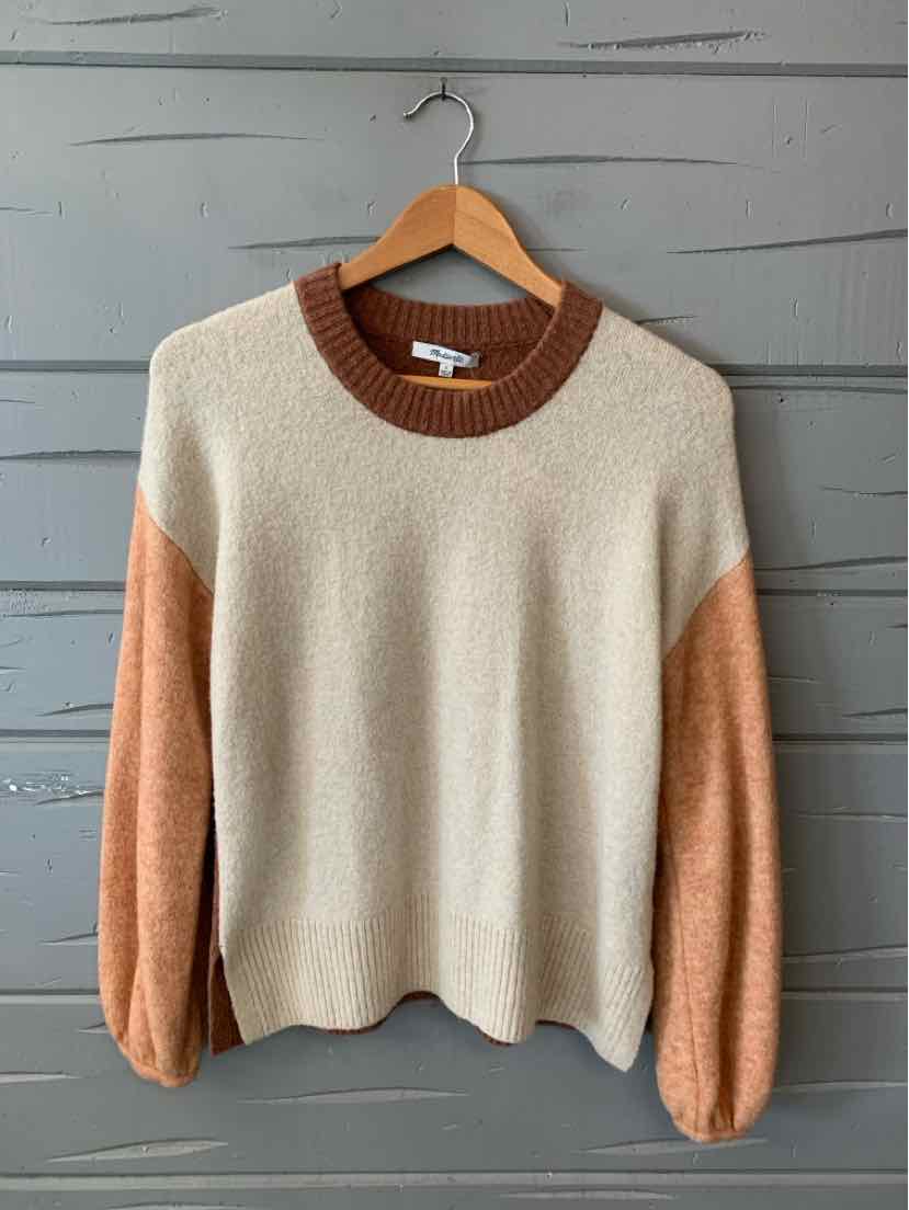 Color-blocked sweater with cream body, rust brown neckline, and peach sleeves, soft knit fabric.