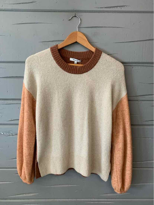 Color-blocked sweater with cream body, rust brown neckline, and peach sleeves, soft knit fabric.