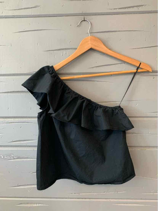 Black one-shoulder sleeveless top with ruffled neckline on wooden hanger.