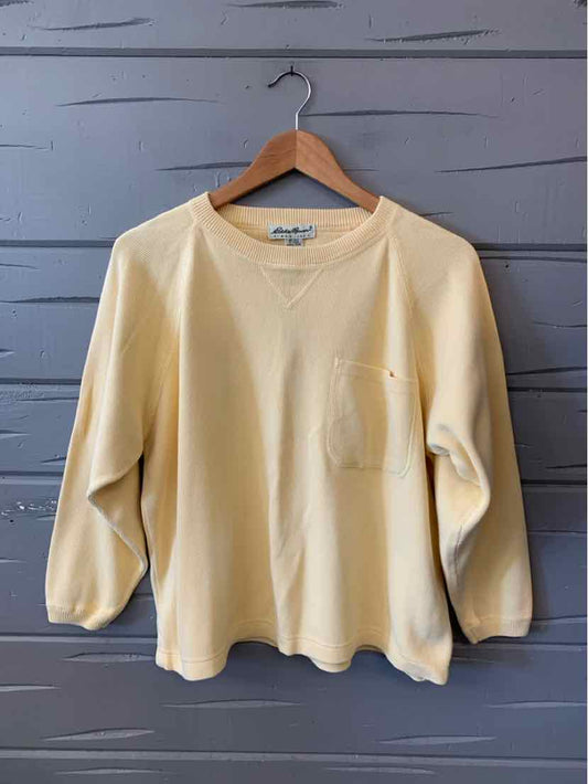 Solid pale yellow Eddie Bauer sweatshirt with a crew neck, long sleeves, and a front patch pocket.