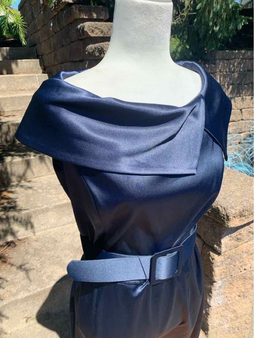 Navy blue satin sleeveless dress with wide folded neckline and matching belt at the waist.