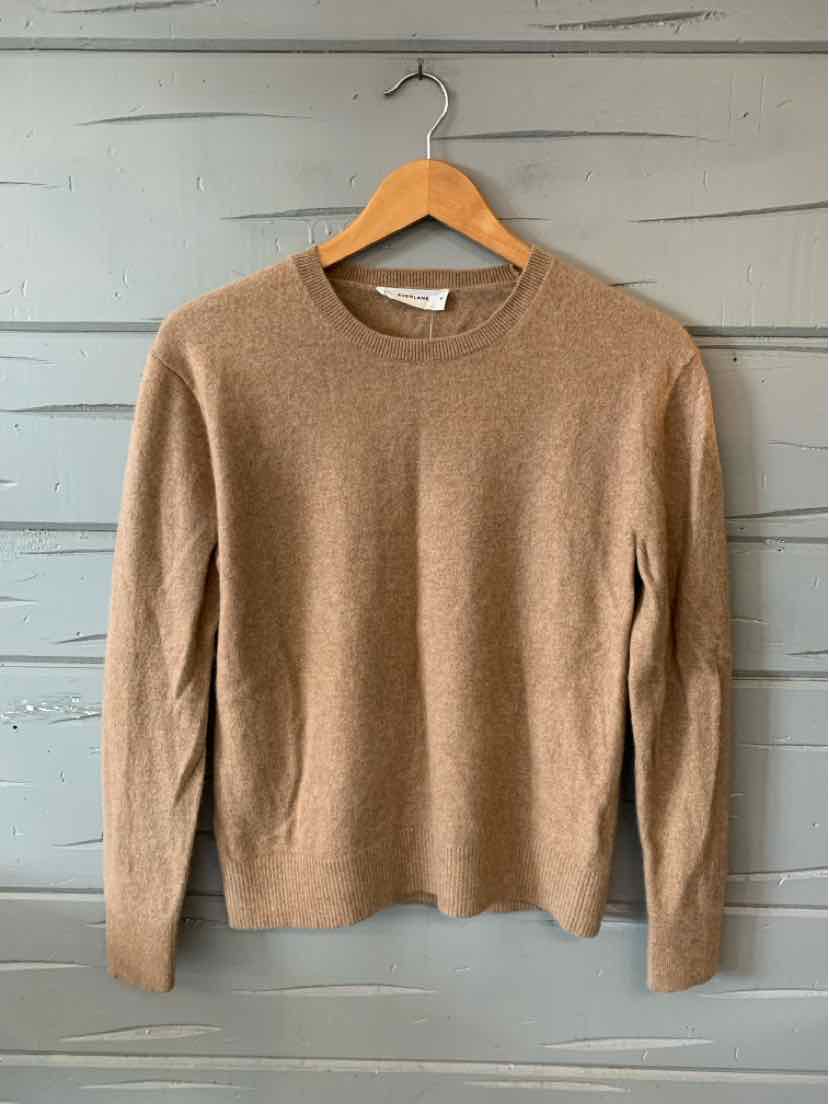 Tan crewneck long-sleeve sweater in medium size with a soft knit texture.