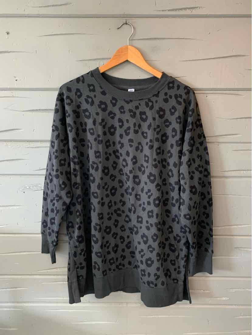 Long-sleeve gray sweatshirt with black leopard print and crew neckline hanging on wooden hanger.