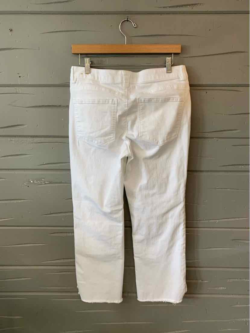White denim jeans with a straight-leg cut, back pockets, and belt loops hanging on a wooden hanger.