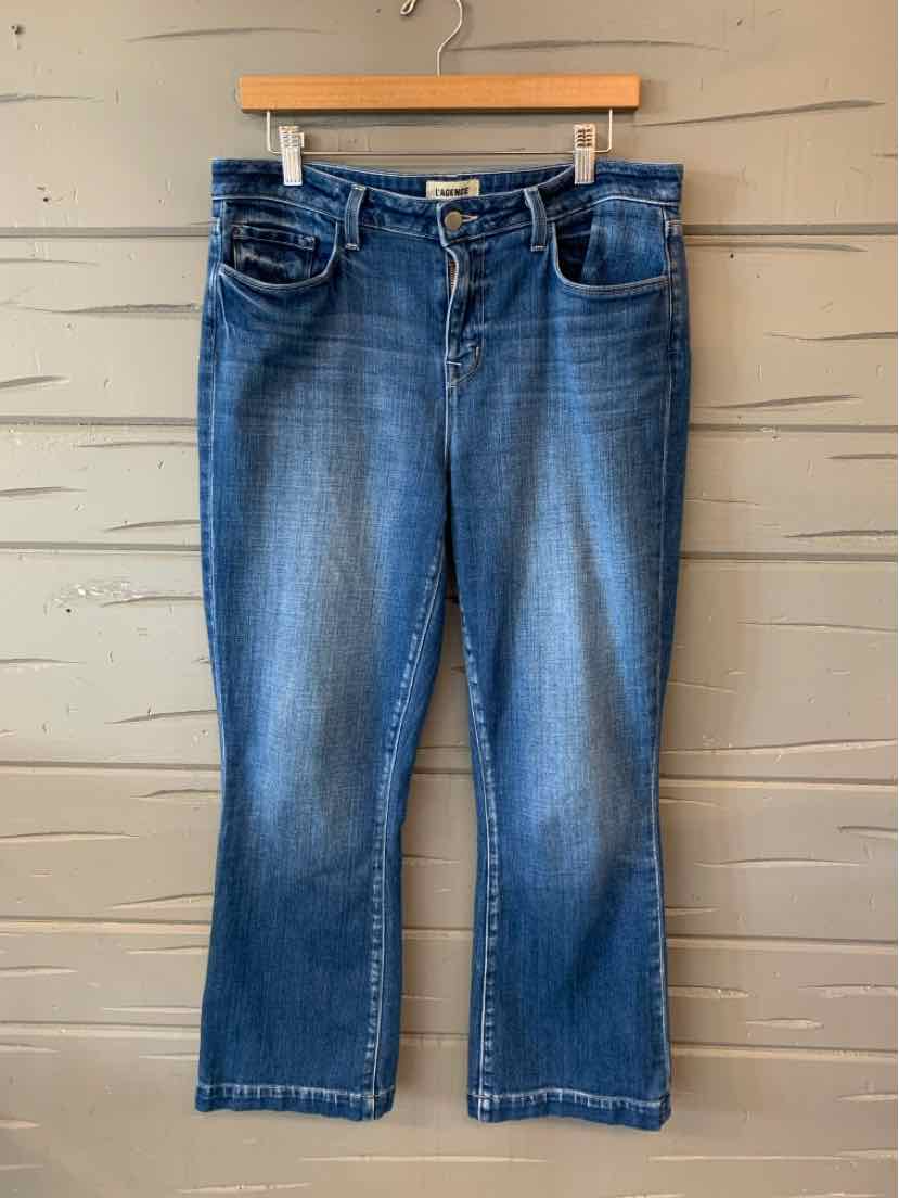 Blue denim jeans with slight fading on front thighs, classic five-pocket style, straight leg cut.