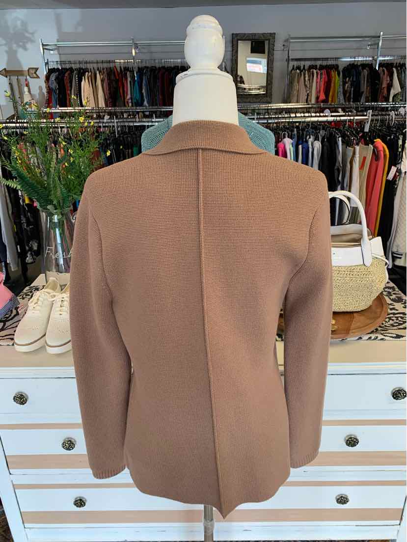 Tan tailored blazer with structured shoulders and clean back seam detailing on mannequin.