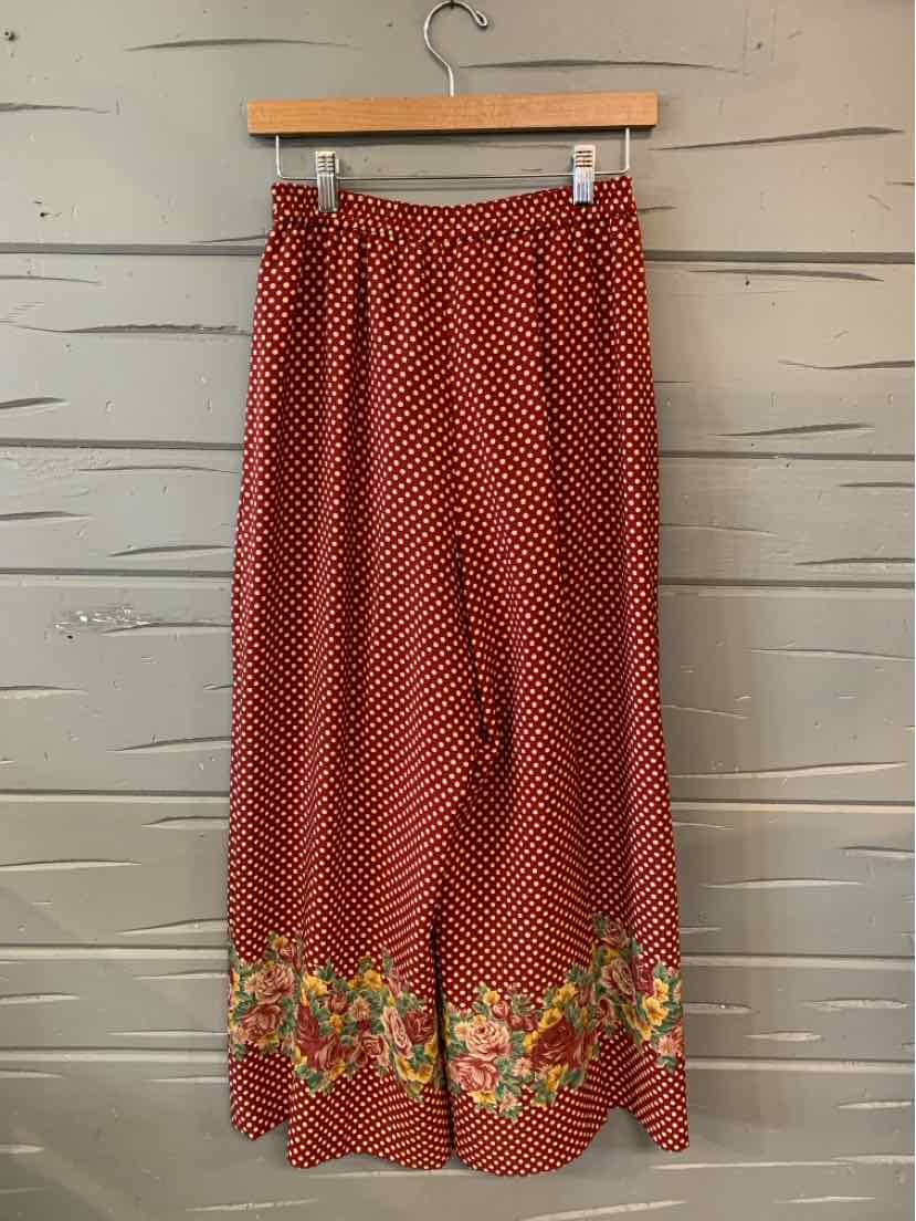 Red wide-leg pants with white polka dots and floral border print at hem in size small.