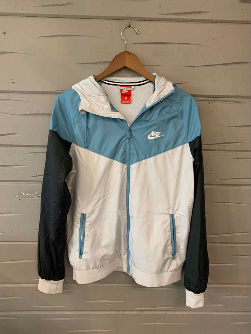 Colorblock Nike zip-up windbreaker jacket in white, teal, and black with hood and front pockets.