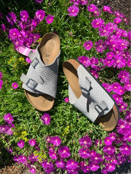 Beige Birkenstock sandals with double adjustable straps and contoured cork footbeds, size 41.