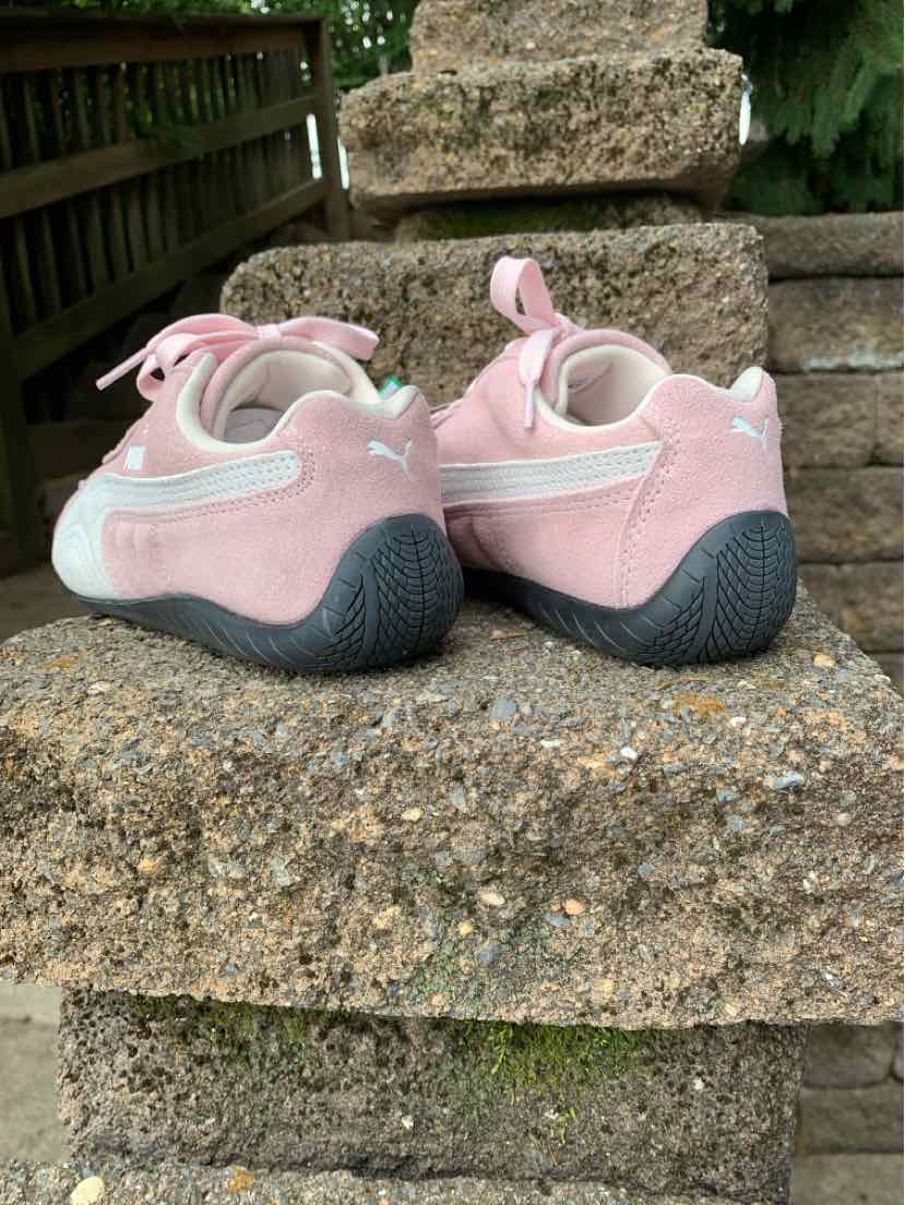 Women's Puma suede sneakers in pink and white with rounded toes and black textured soles, size 6.5.