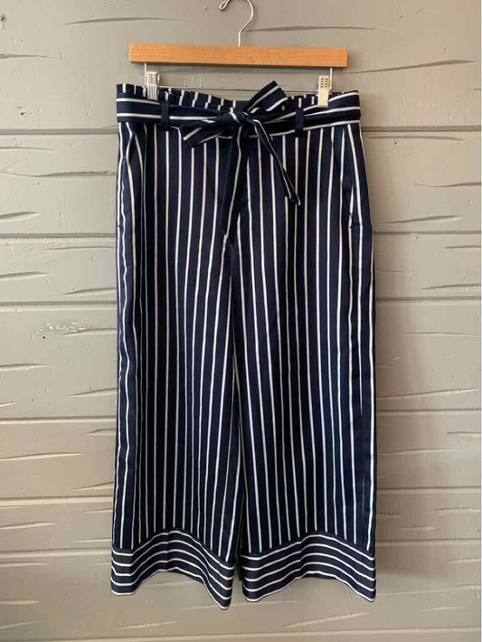Navy blue wide-leg pants with white vertical stripes and a matching fabric belt, size 6.