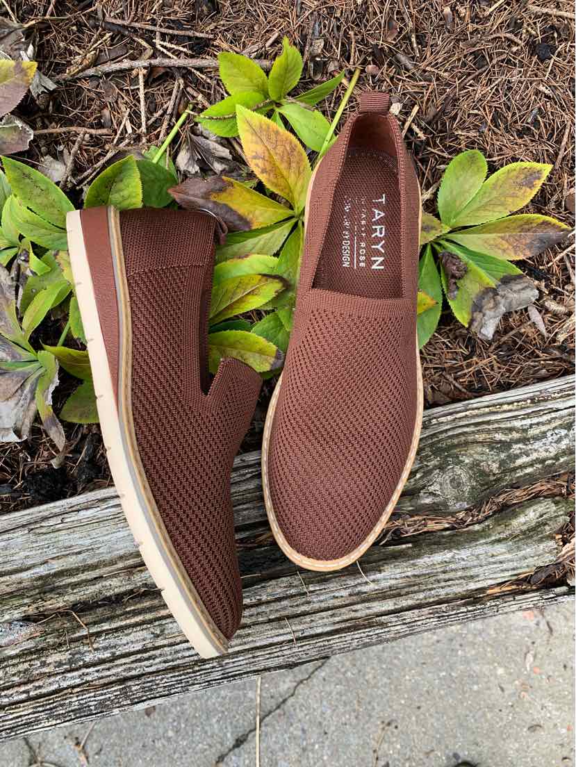 Womens brick-colored slip-on shoes with textured fabric upper and white rubber sole.