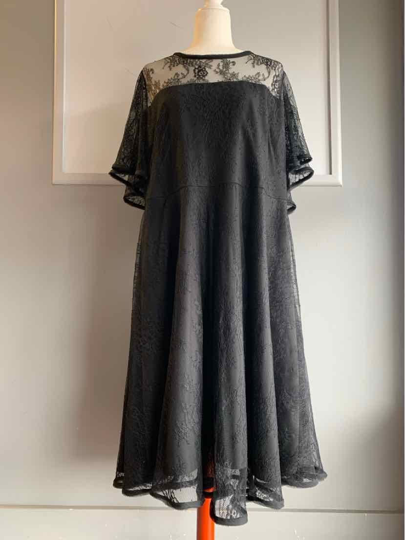 Black lace midi dress with sheer floral yoke and elbow-length sleeves on mannequin.