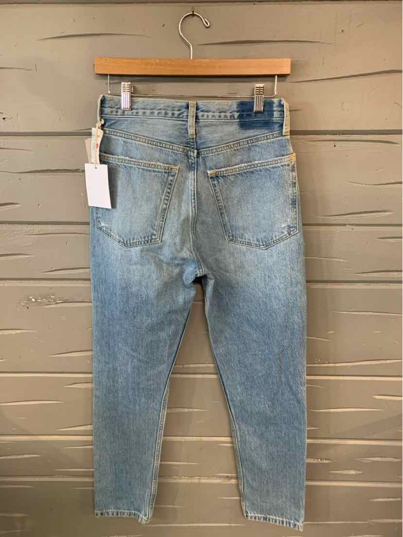 Light blue denim jeans with a straight fit, back pockets, and leather patch on the waistband.