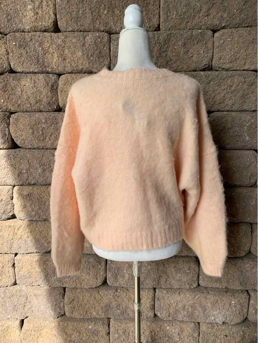 Solid peach pullover sweater with a soft fuzzy knit, crew neck, and long sleeves.