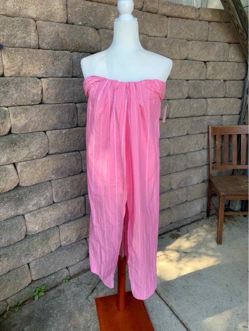 Pink strapless wide-leg jumpsuit with gathered elastic neckline and lightweight fabric.
