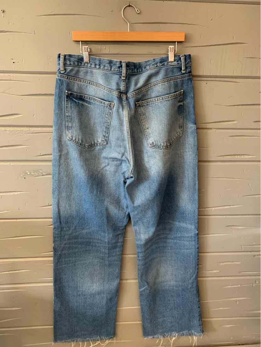 Light blue high-waisted denim jeans with back pockets and raw hem detailing.