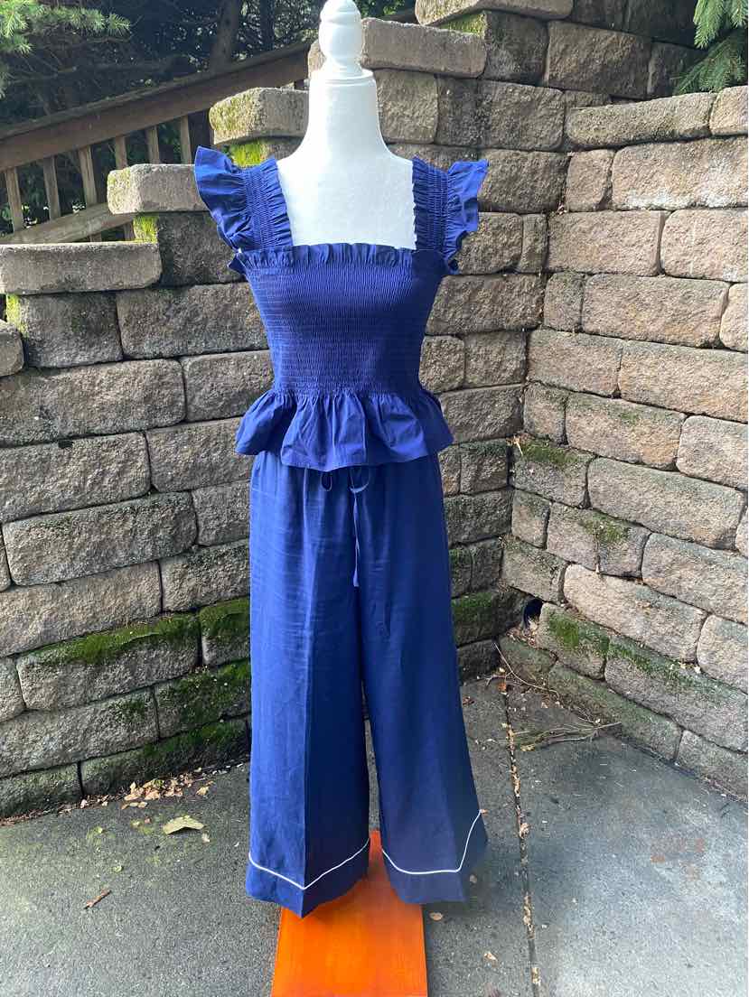 Navy blue two-piece set with ruffled square neckline top and wide-leg pants with white stitching.