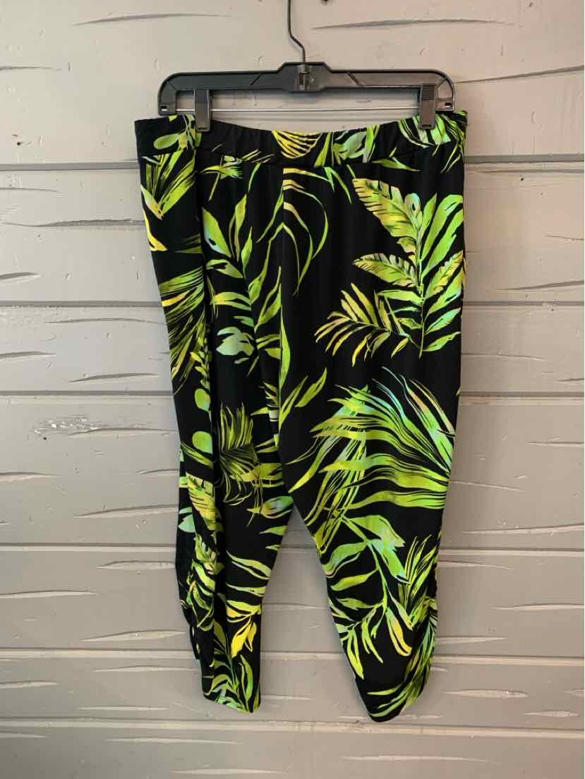 Black pants with green tropical leaf print and elastic waistband and cuffs.