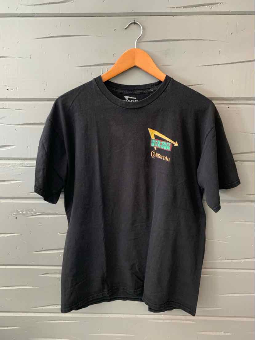 Black short-sleeve cotton t-shirt with colorful geometric graphic on chest and crew neckline.