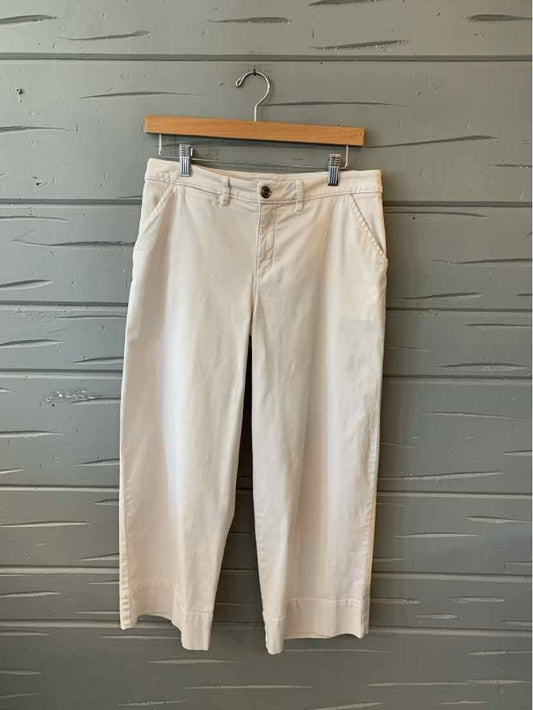 Light beige straight-leg pants with button and zipper closure, front pockets, and belt loops.