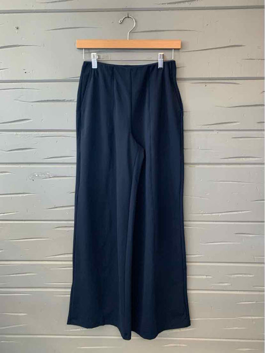 Navy blue Old Navy wide-leg trousers with a smooth finish, hanging from a wooden clip hanger.