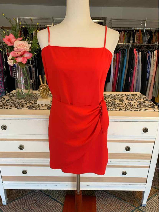 Red sleeveless mini dress with spaghetti straps and side ruching on mannequin.