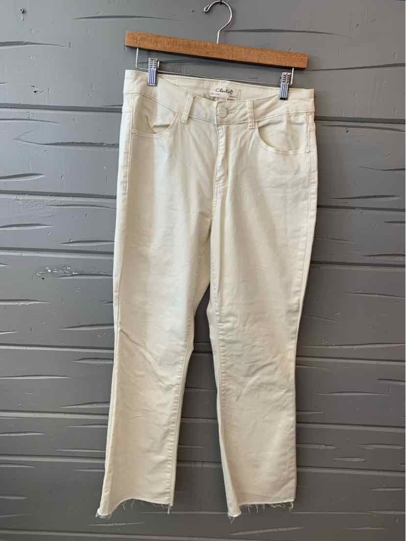 Cream-colored straight-leg pants with front pockets and belt loops hanging on wooden hanger.