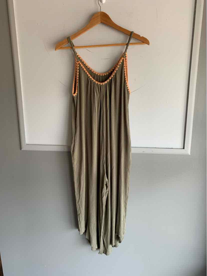 Olive green sleeveless jumpsuit with orange braided straps and relaxed fit hanging on wooden hanger.