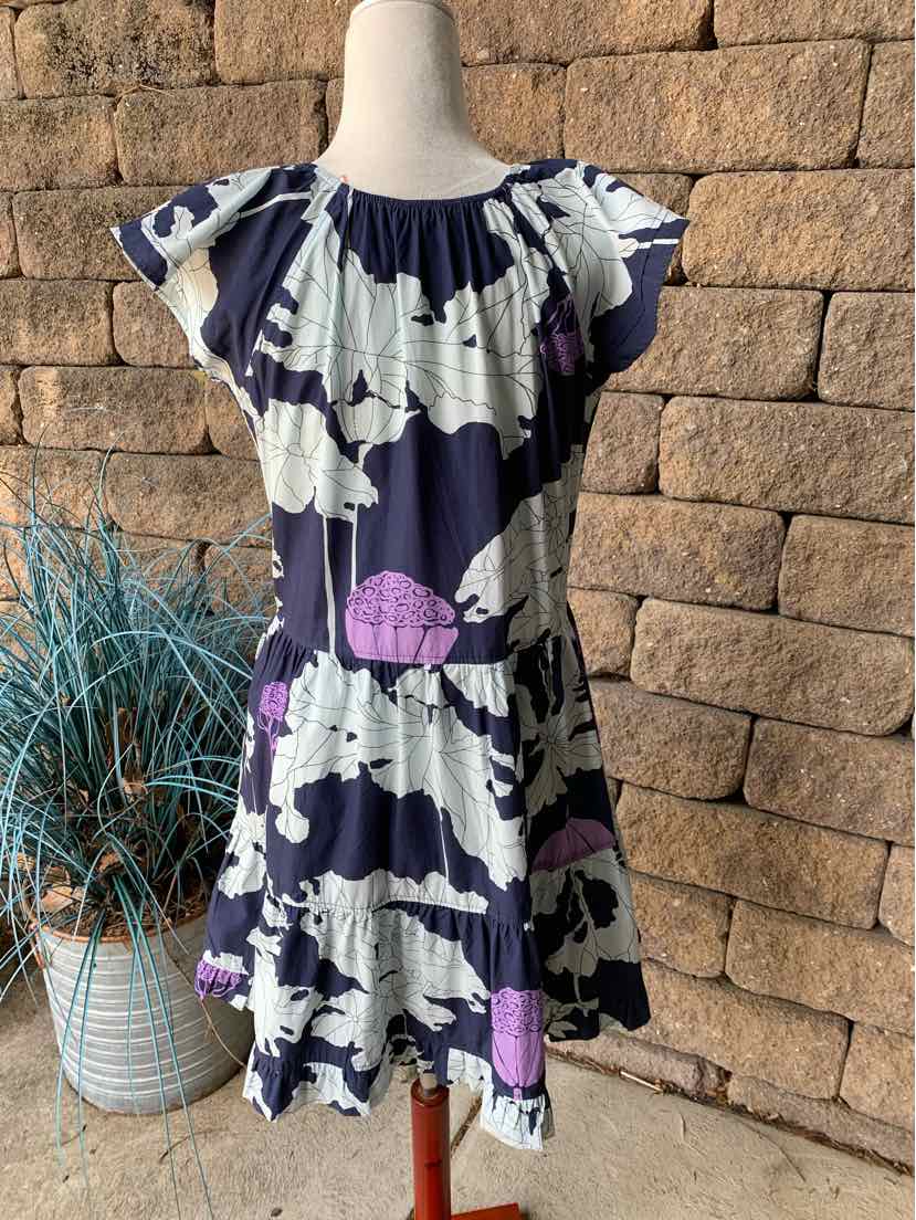 Navy blue dress with large white and purple floral print, flutter sleeves, gathered neckline, and ruffled hem in medium size.