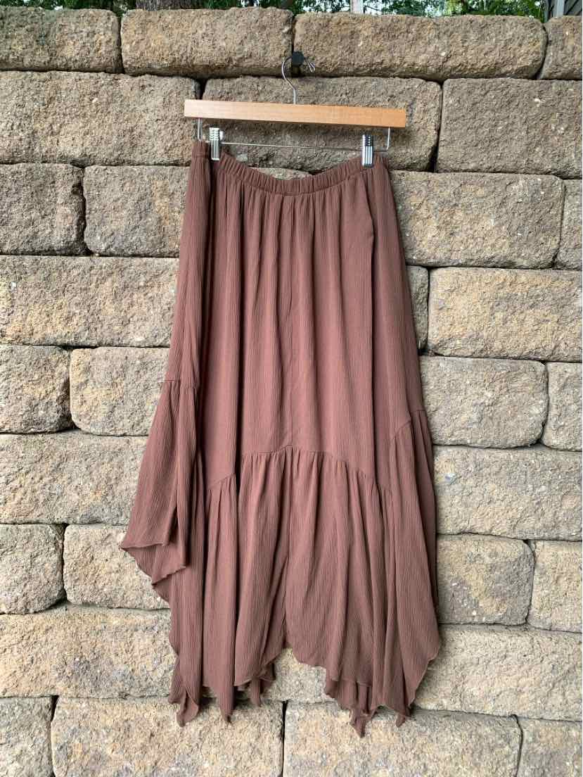 Brown asymmetrical midi skirt with gathered waist and flowing tiered hem.