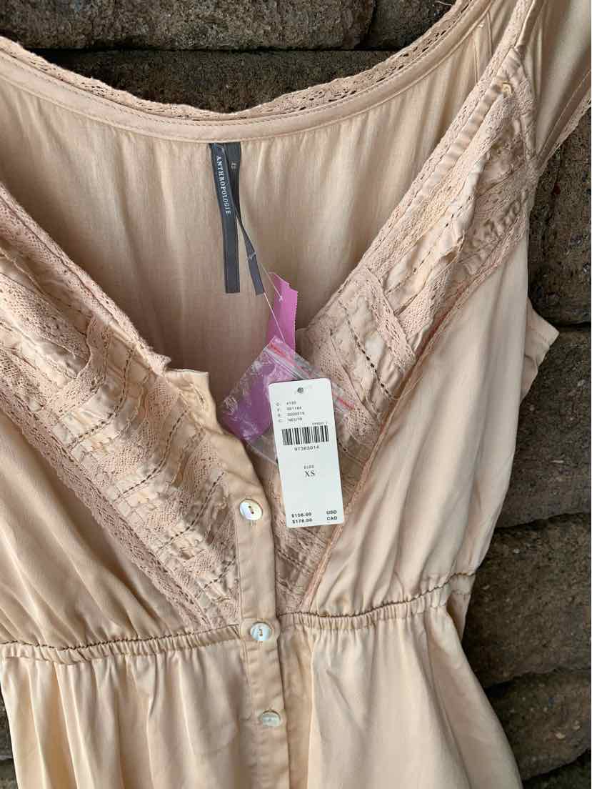 Tan sleeveless dress with lace trim along neckline and button-down front in size XS.