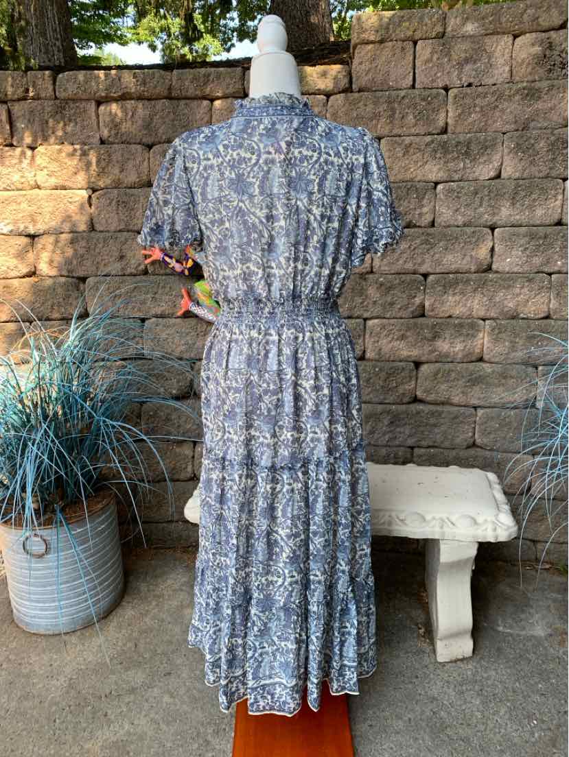 Blue floral short-sleeve midi dress with cinched waist and tiered skirt on mannequin.