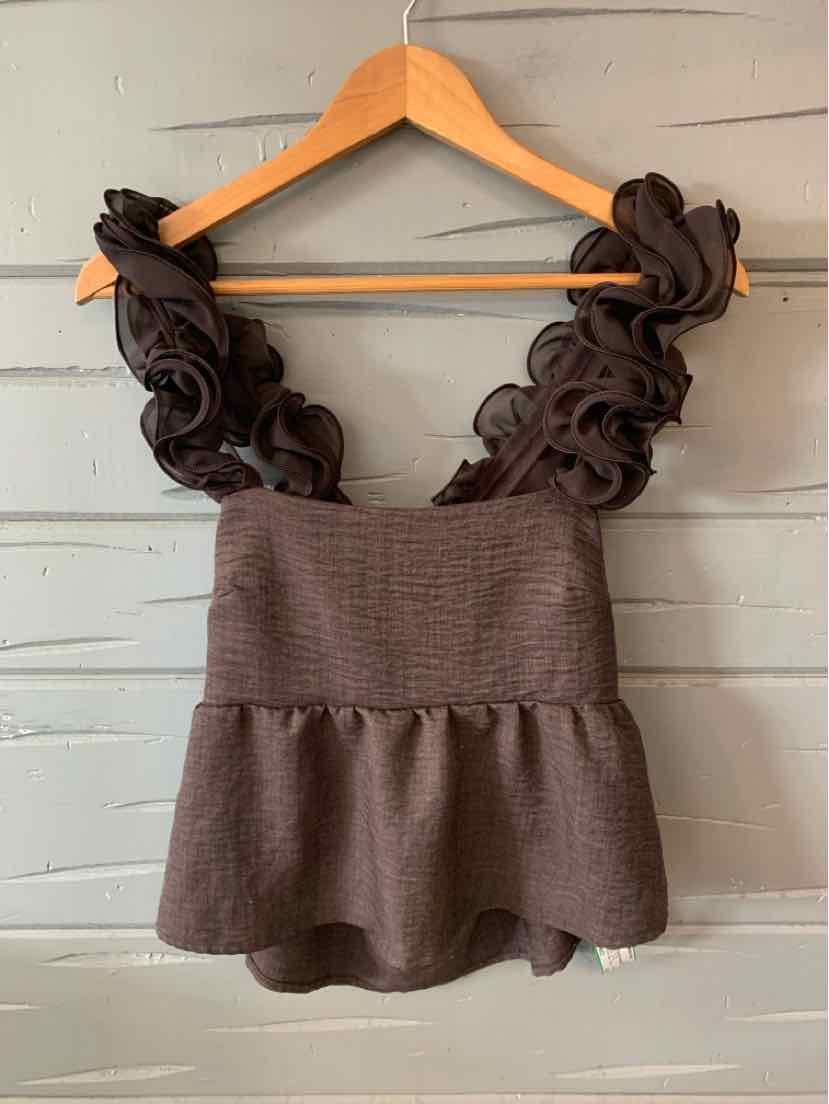 Brown sleeveless blouse with ruffled shoulder straps and peplum hem, textured fabric.
