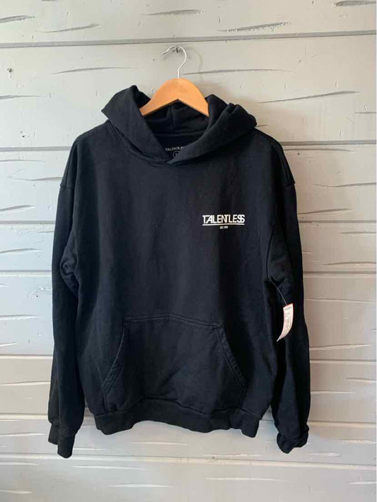 Black oversized hoodie with front pocket, white "TALENTLESS" logo on chest, and attached hood.