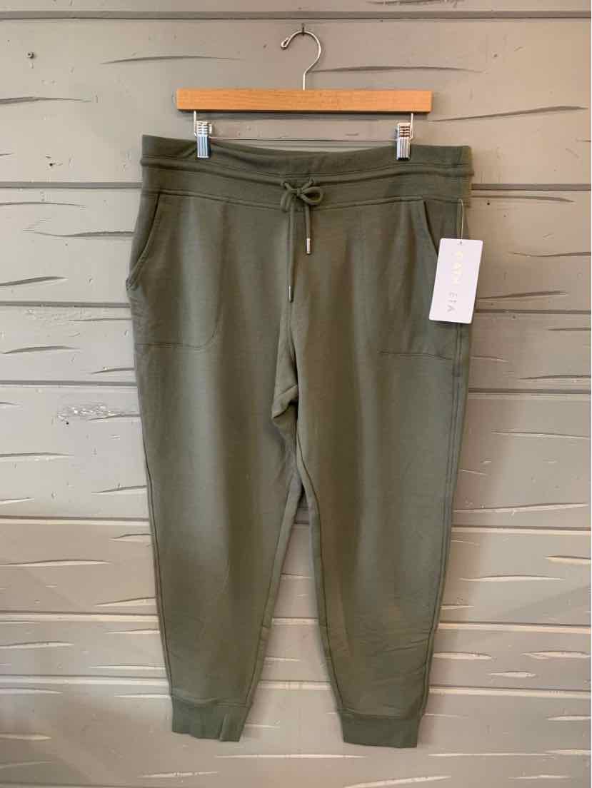 Olive green tapered joggers with elastic waistband, drawstring, side pockets, and ribbed cuffs in size XL.