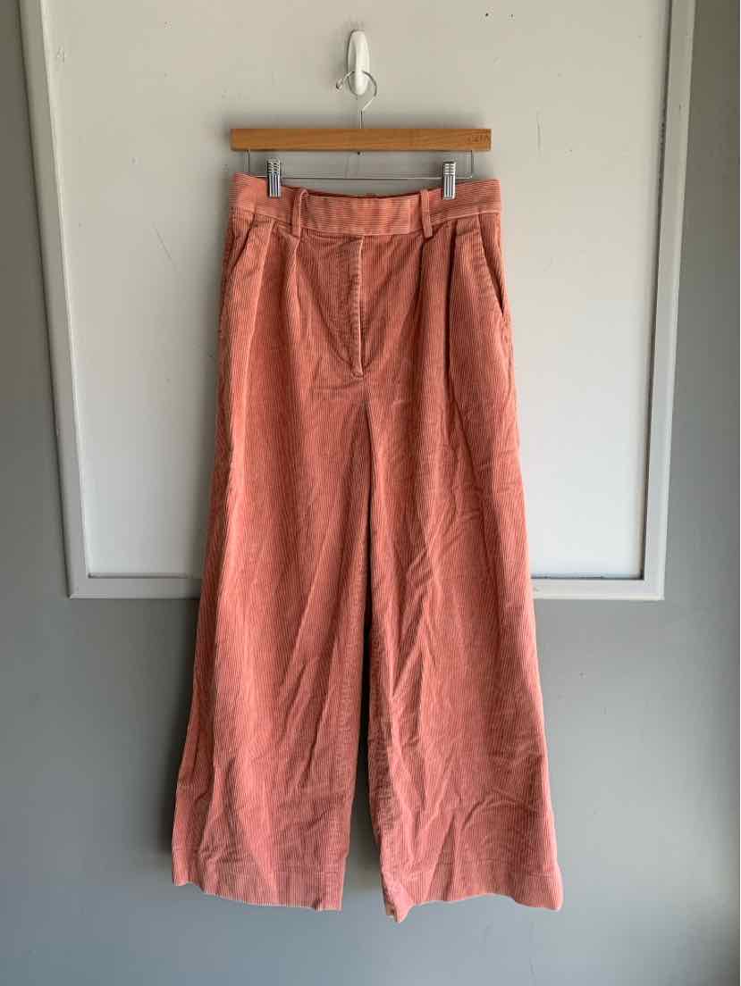 Wide-leg pink corduroy pants with pleated front and side pockets, size 8.