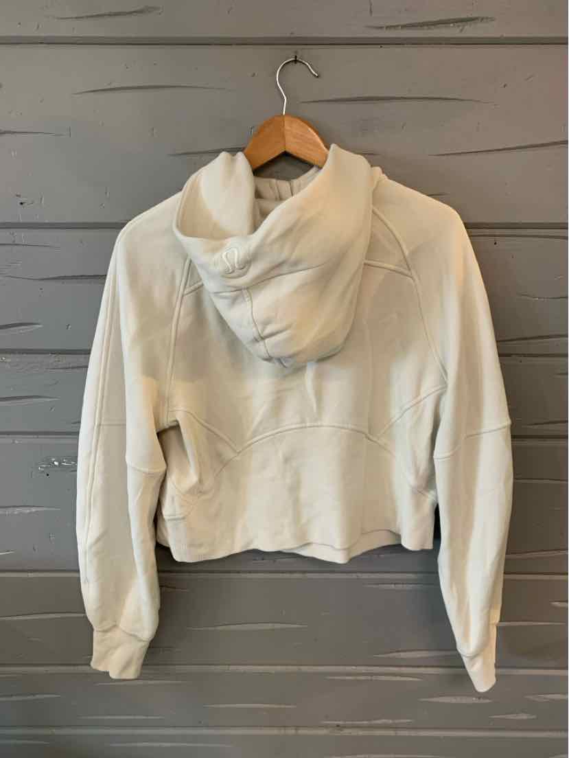 Cream-colored cropped hoodie with long sleeves and roomy hood, soft fabric, size XS/S.