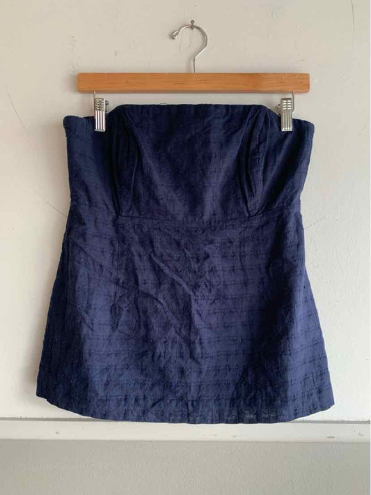 Navy blue strapless textured mini dress with a fitted bodice hanging on wooden hanger.
