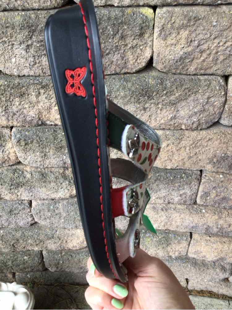 Black wedge sandal with red stitching and metallic cherry-patterned straps, size 39.