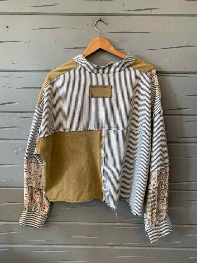 Gray and mustard patchwork pullover sweater with floral-print sleeves, ribbed cuffs, and a chest label.