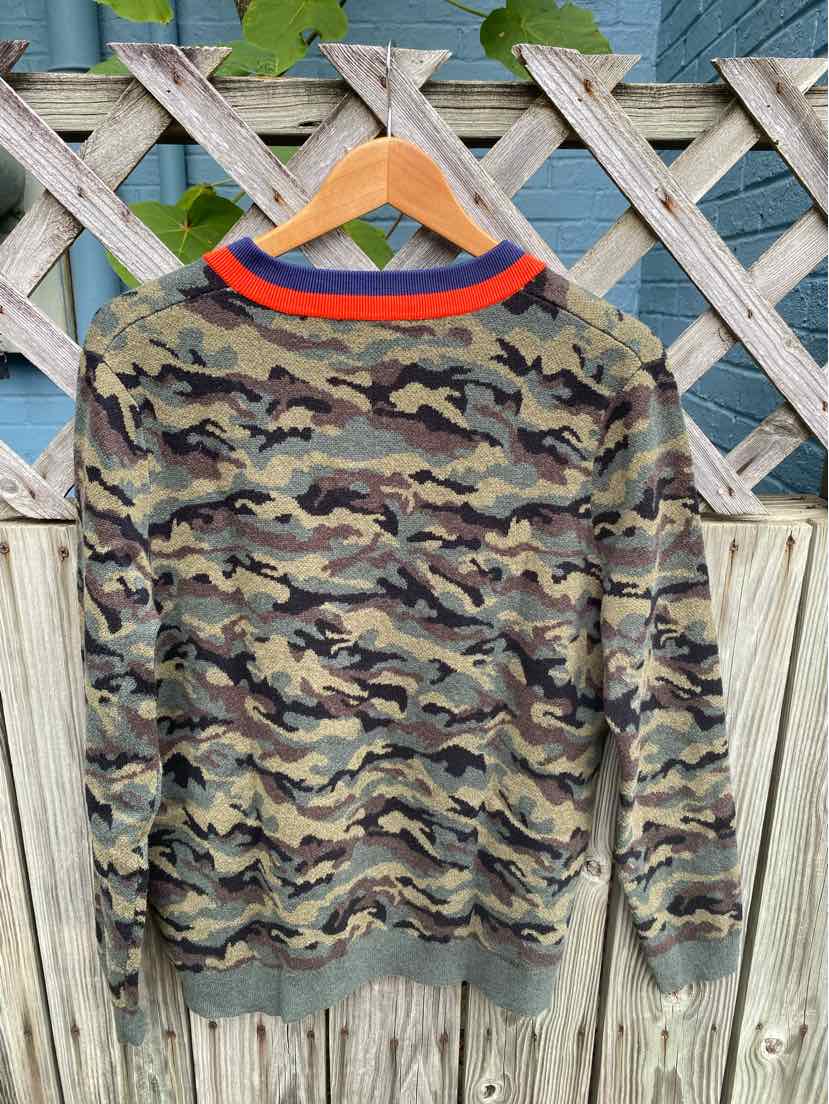 Camouflage long-sleeve sweater with ribbed cuffs and hem, red and navy striped collar detail.
