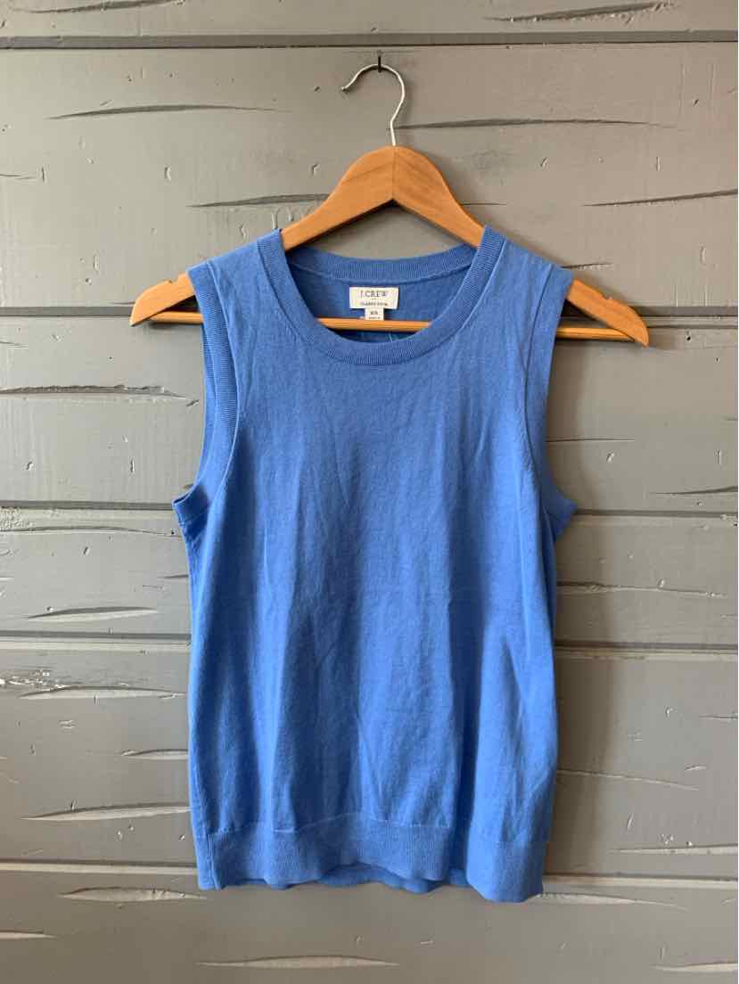 Sleeveless blue knit tank top with crew neck and fitted silhouette on wooden hanger.