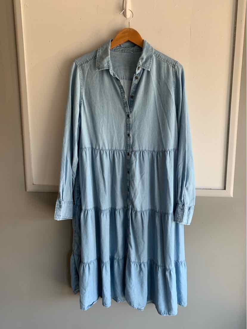 Light blue long-sleeve tiered dress with button-down front and collar in soft fabric.