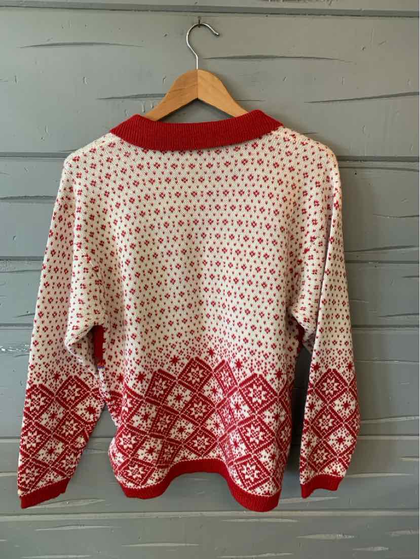 Red and white patterned knit sweater with geometric designs and ribbed collar, cuffs, and hem.