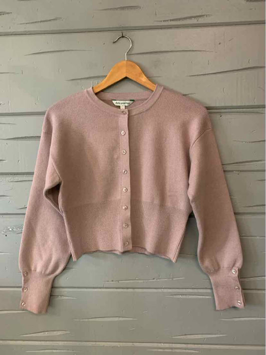 Mauve cropped knit cardigan with a round neckline, button front, and long sleeves.
