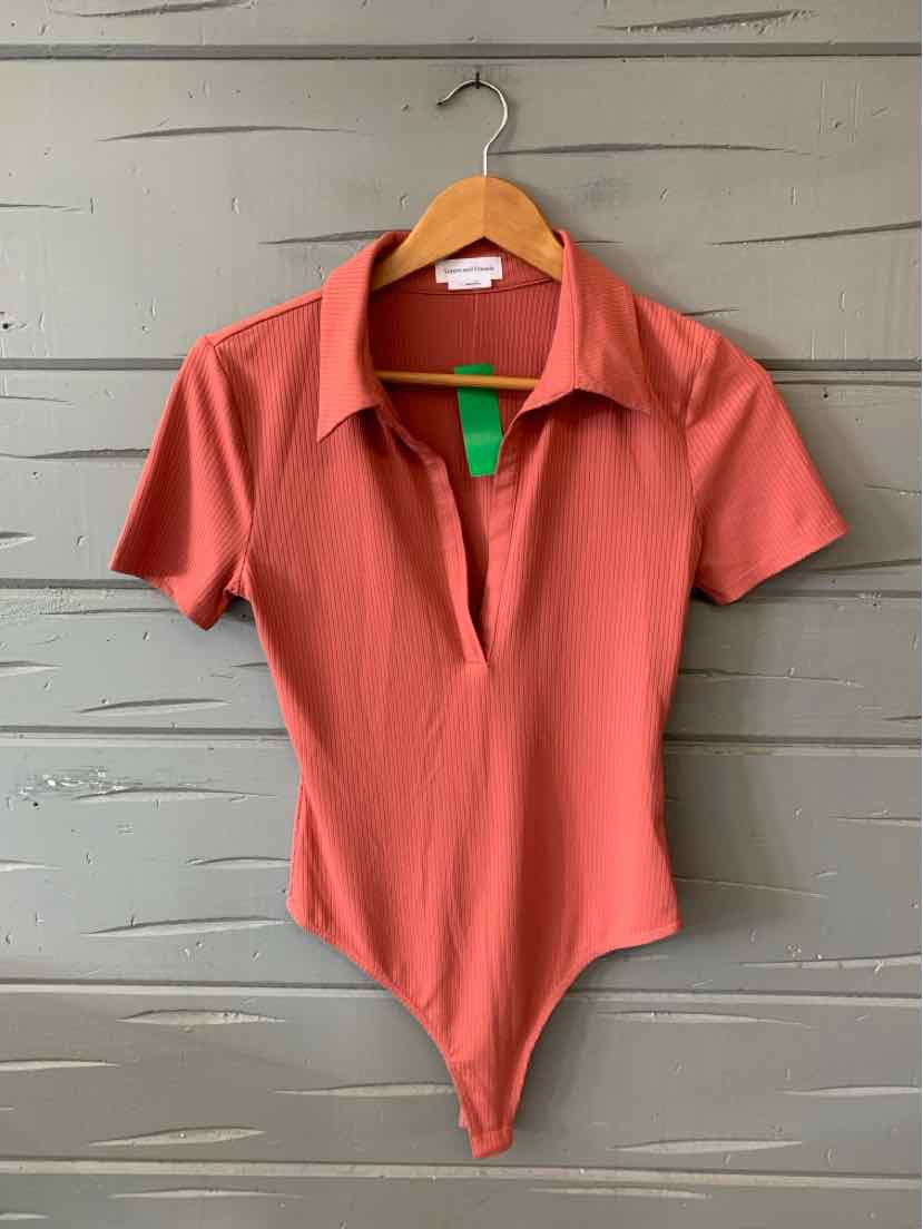 Rust-colored short sleeve bodysuit with collared neckline and deep V opening, fitted silhouette.