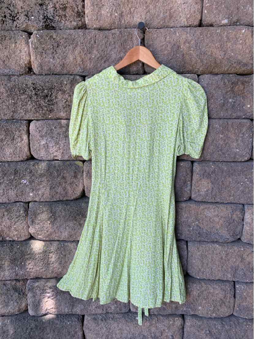 Light green floral short-sleeve dress with puffed shoulders and a flare hem.