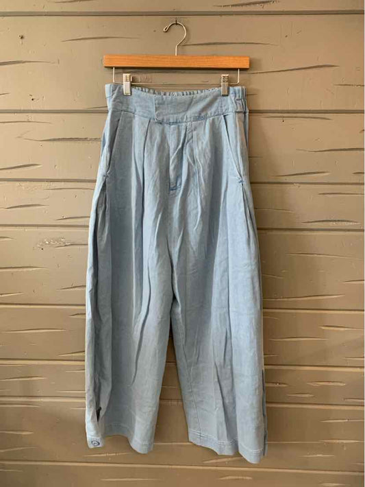 Light blue wide-leg pants with high waist and pleated front, casual lightweight fabric.