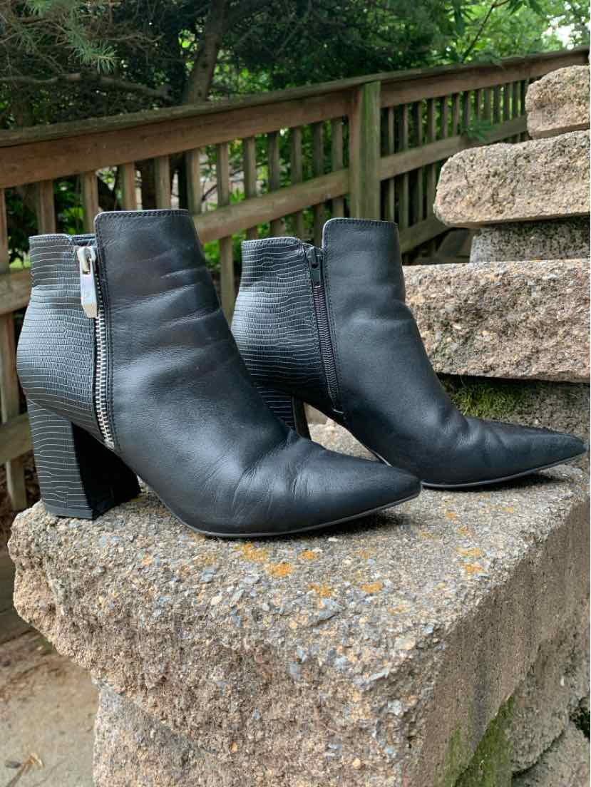 Black leather ankle boots with pointed toes and block heels, side zipper closure.